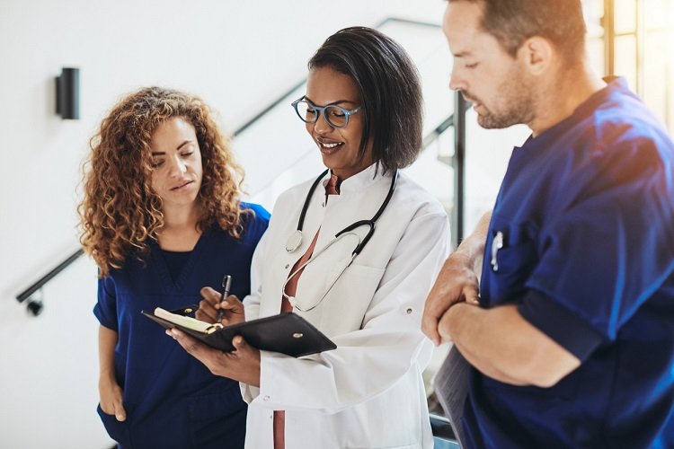 group of diverse doctors talking together in a hospital corridor